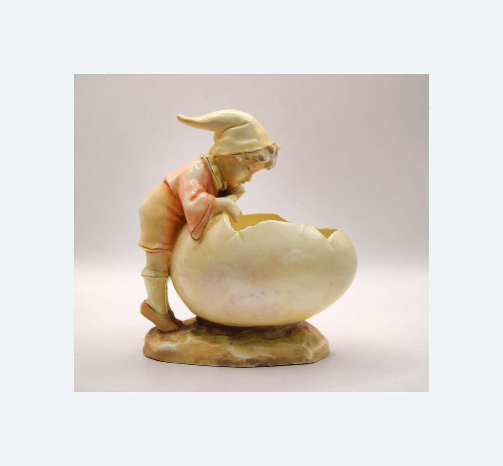 Decorative figurine of a gnome on a shell with a soft background