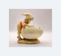 Decorative figurine of a gnome on a shell with a soft background