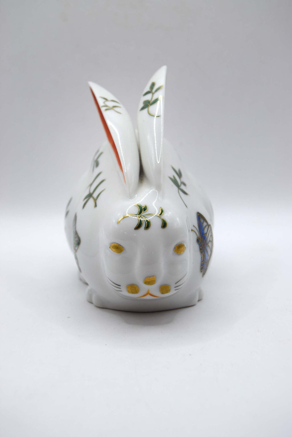 Decorative ceramic rabbit with floral patterns on a white background