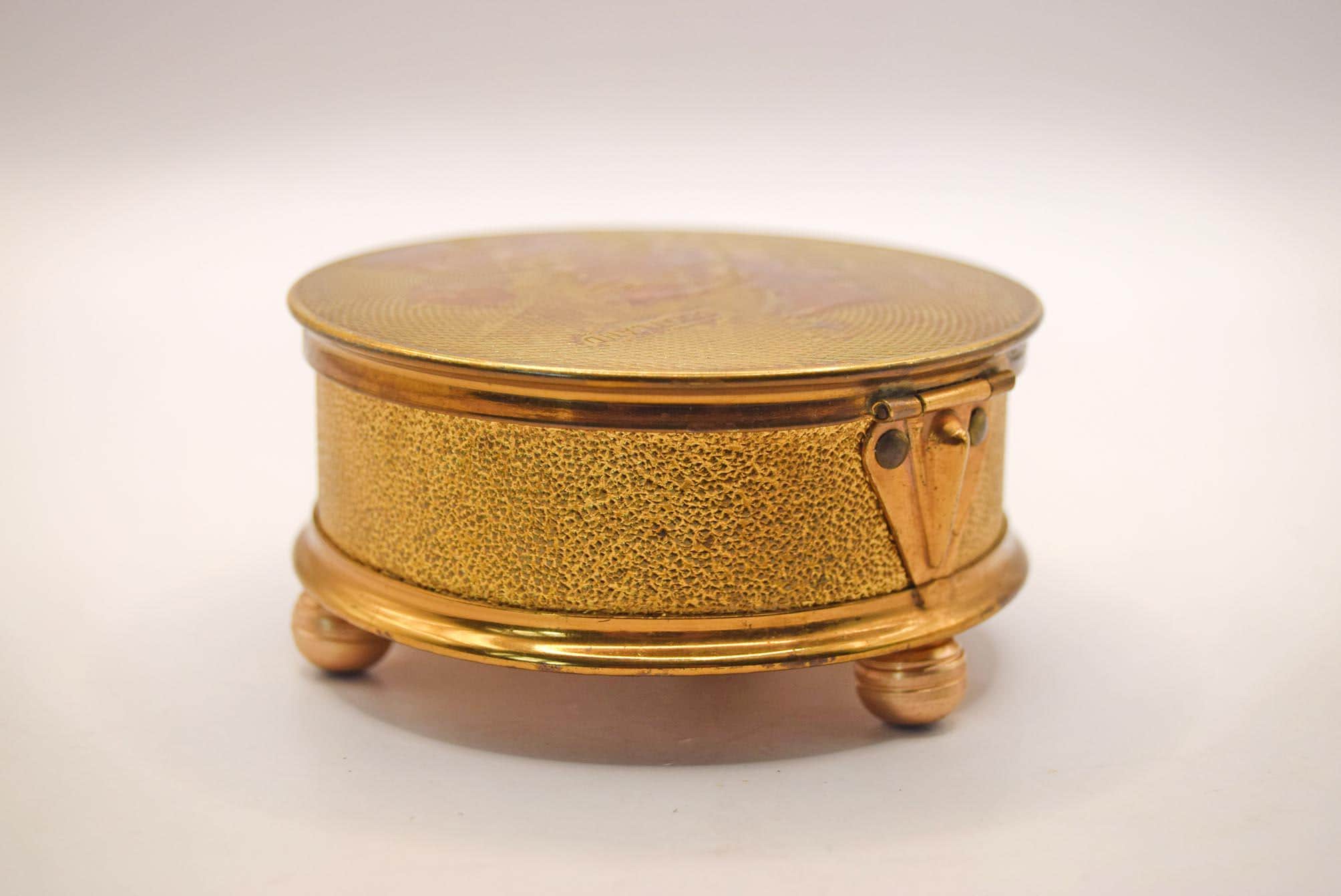 Gold jewelry box with a textured surface on a white background