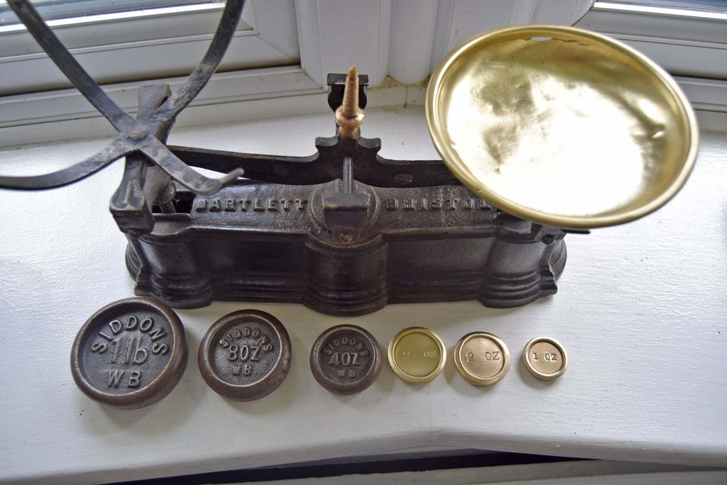 Vintage scale with weights on a white surface