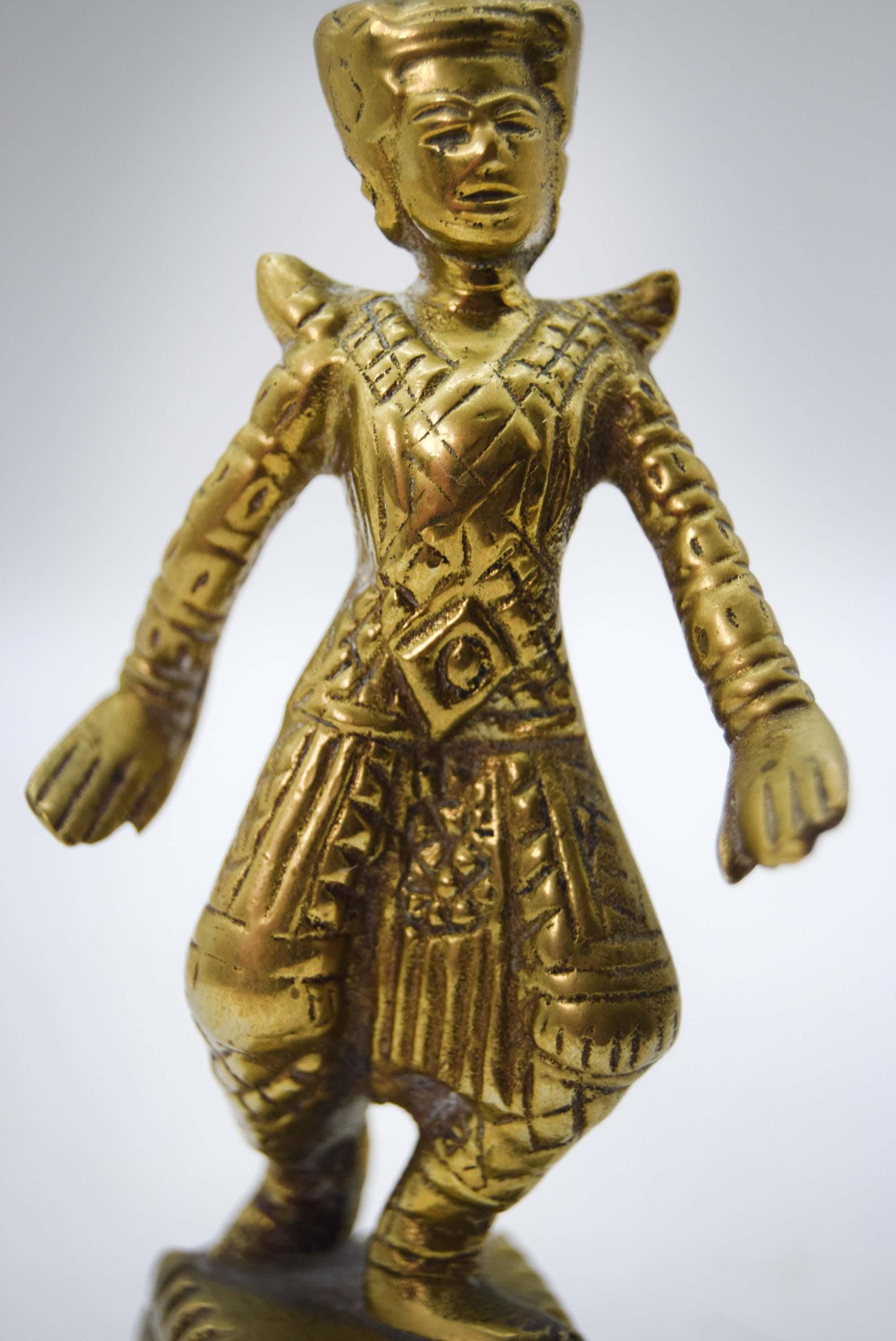 Brass figurine of a warrior on a white background