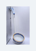 Ceramic ladle with floral design on a white background