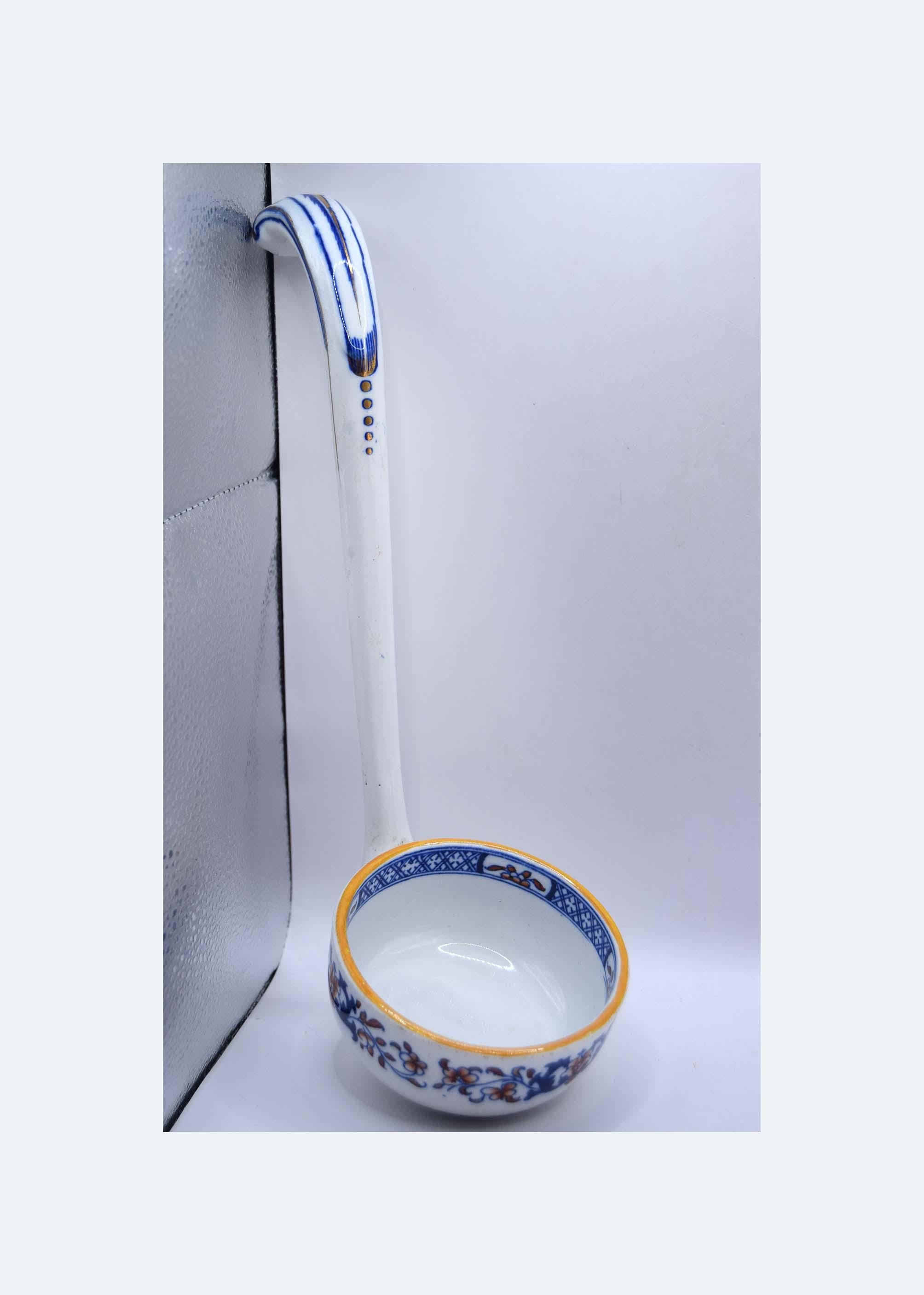 Ceramic ladle with floral design on a white background