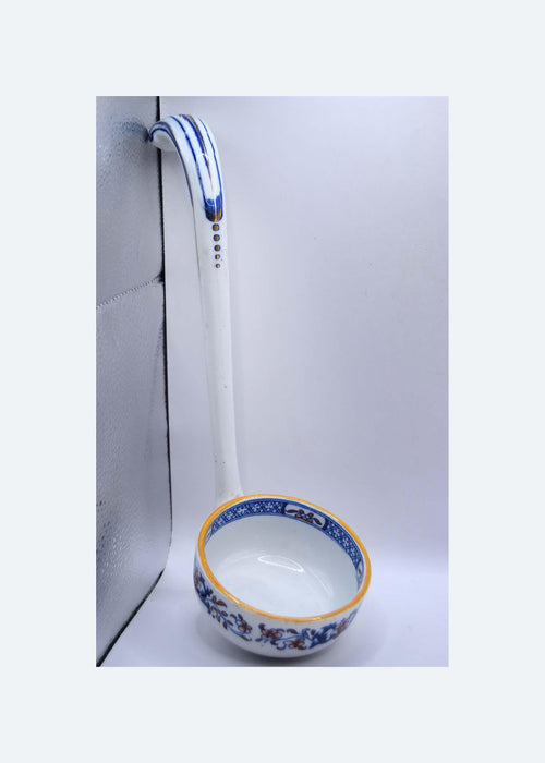 Ceramic ladle with floral design on a white background