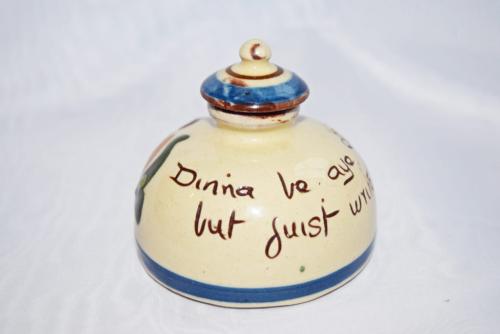 Ceramic jar with blue accents and text on a white background