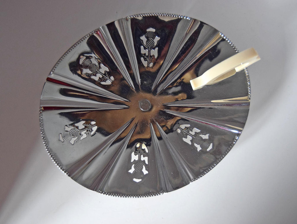 Decorative metal plate with embossed designs on a gray background