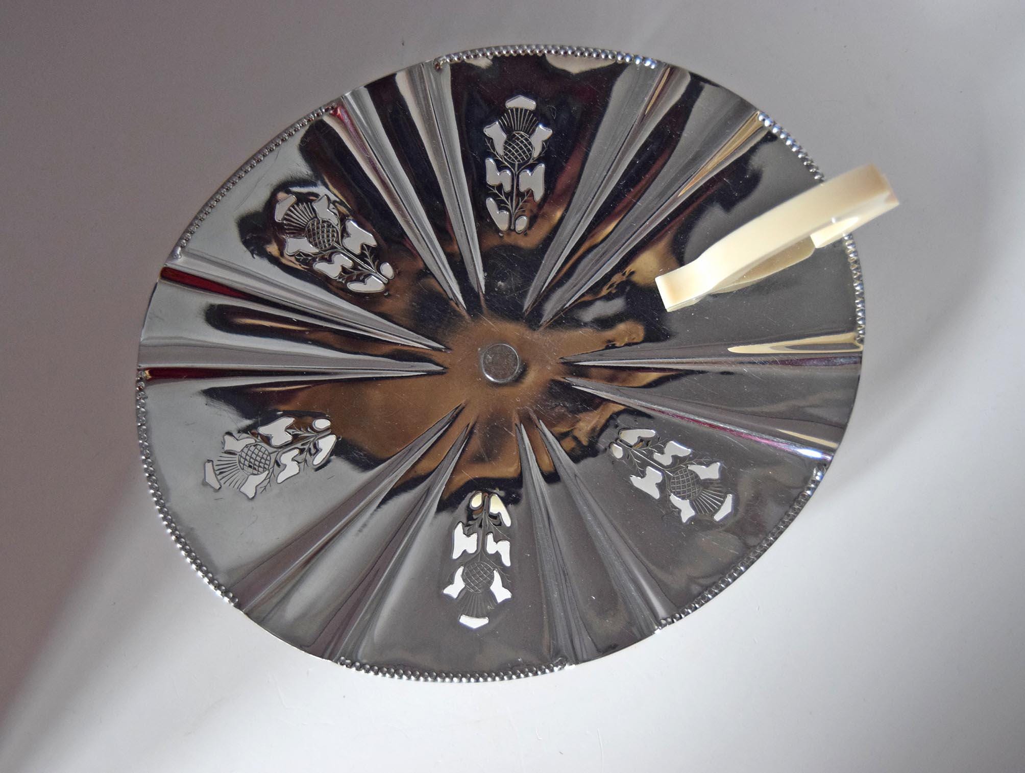Decorative metal plate with embossed designs on a gray background