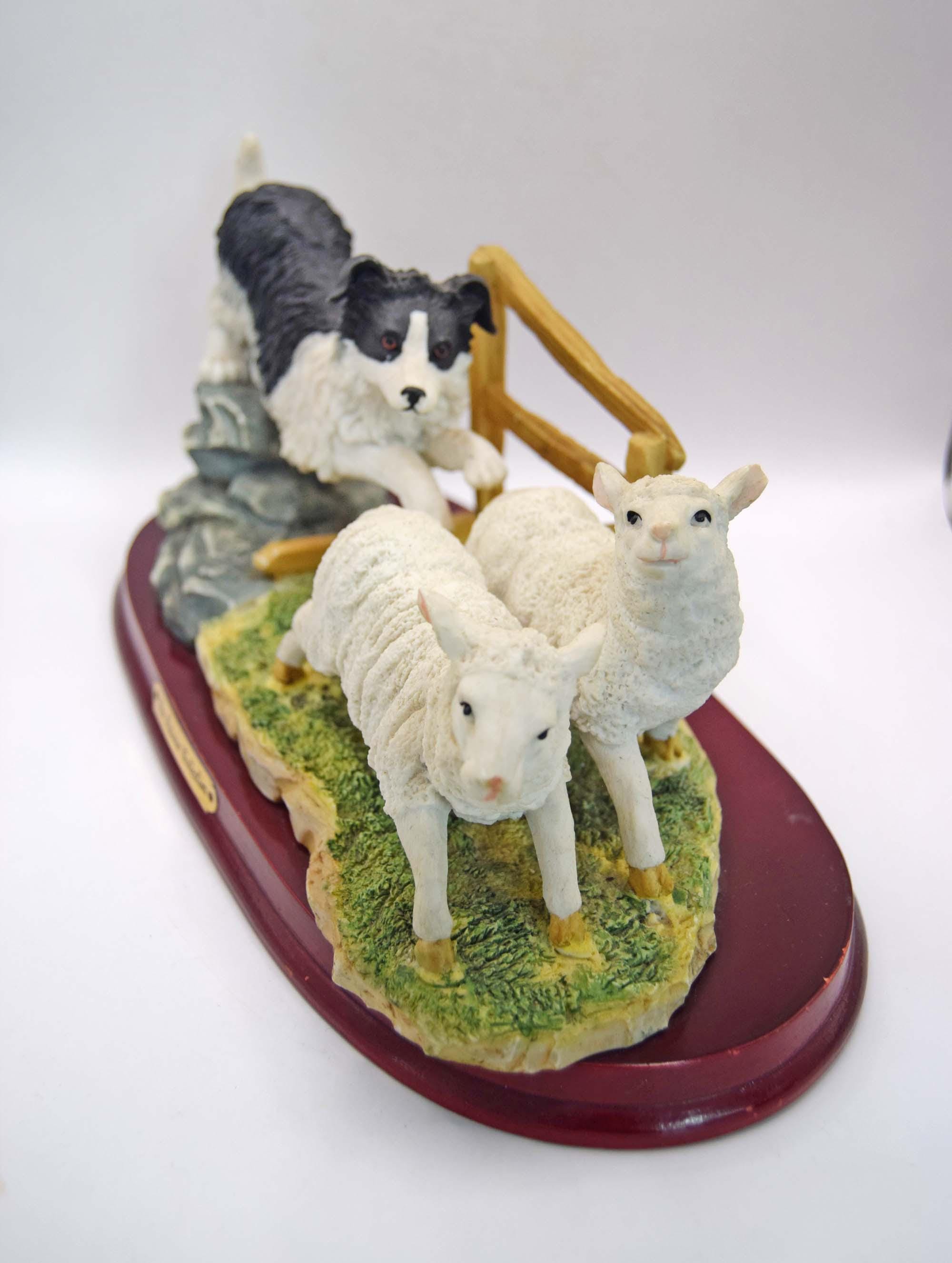 Vintage Juliana Collection figurine depicting a black and white collie sheep dog chasing two sheep.