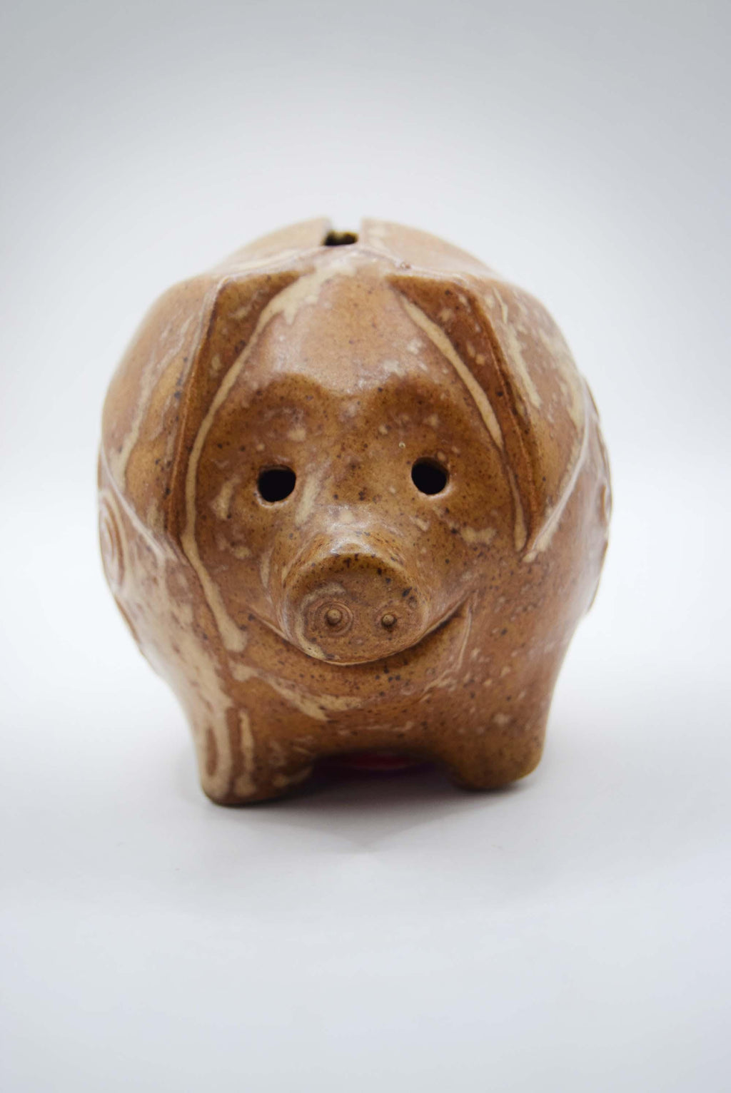 Brown ceramic piggy bank on a white background