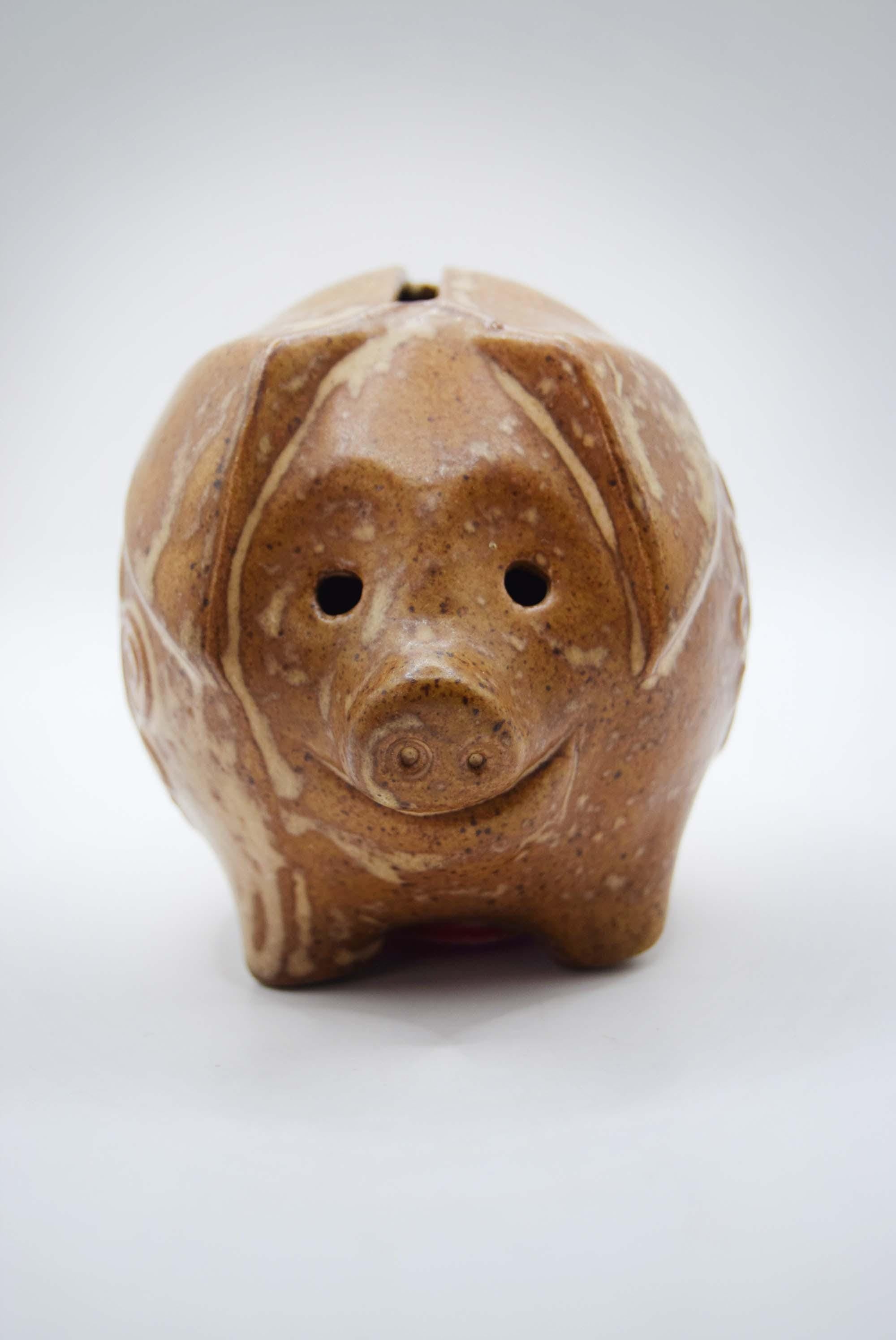 Brown ceramic piggy bank on a white background