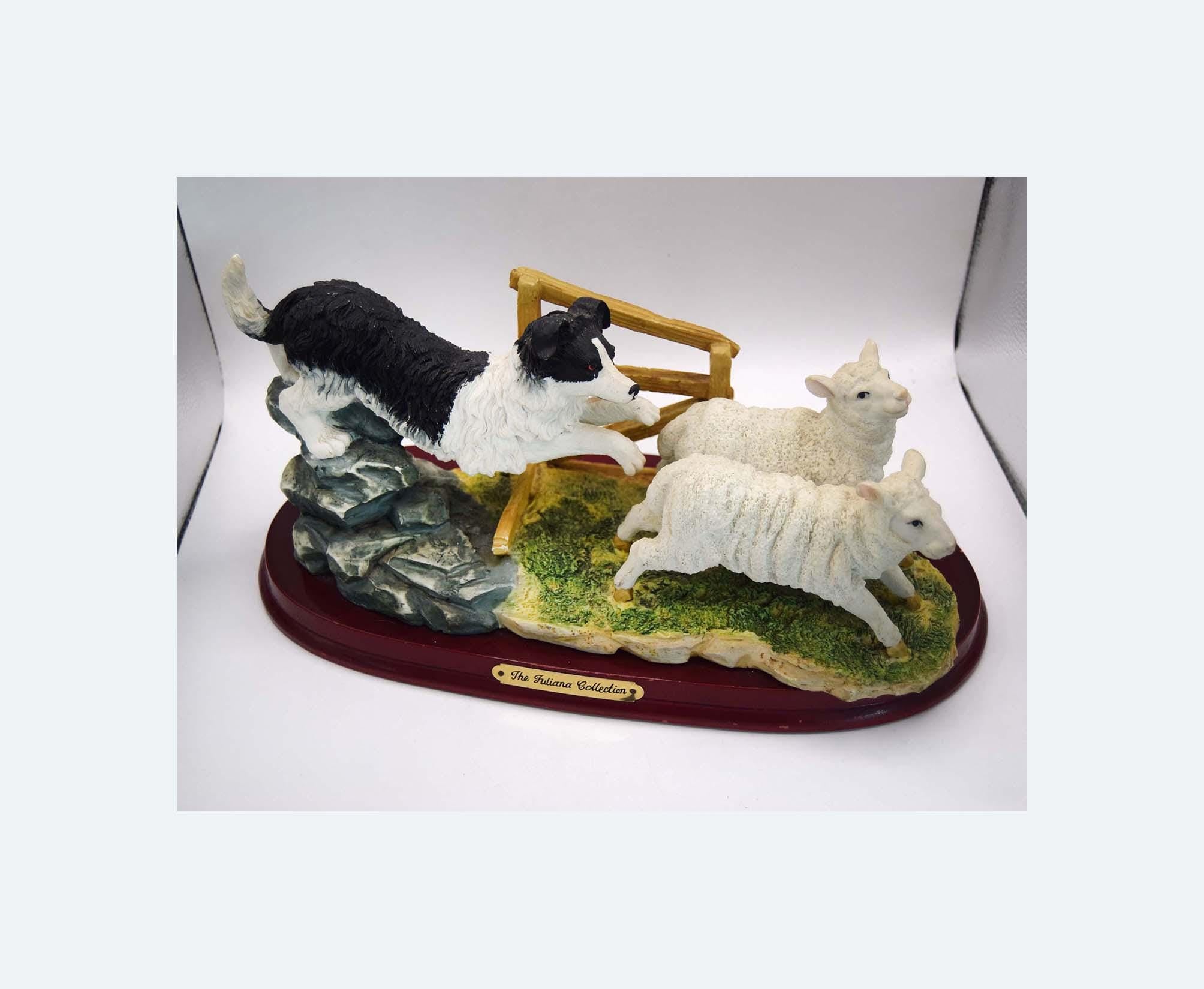 Vintage Juliana Collection figurine depicting a black and white collie sheep dog chasing two sheep.