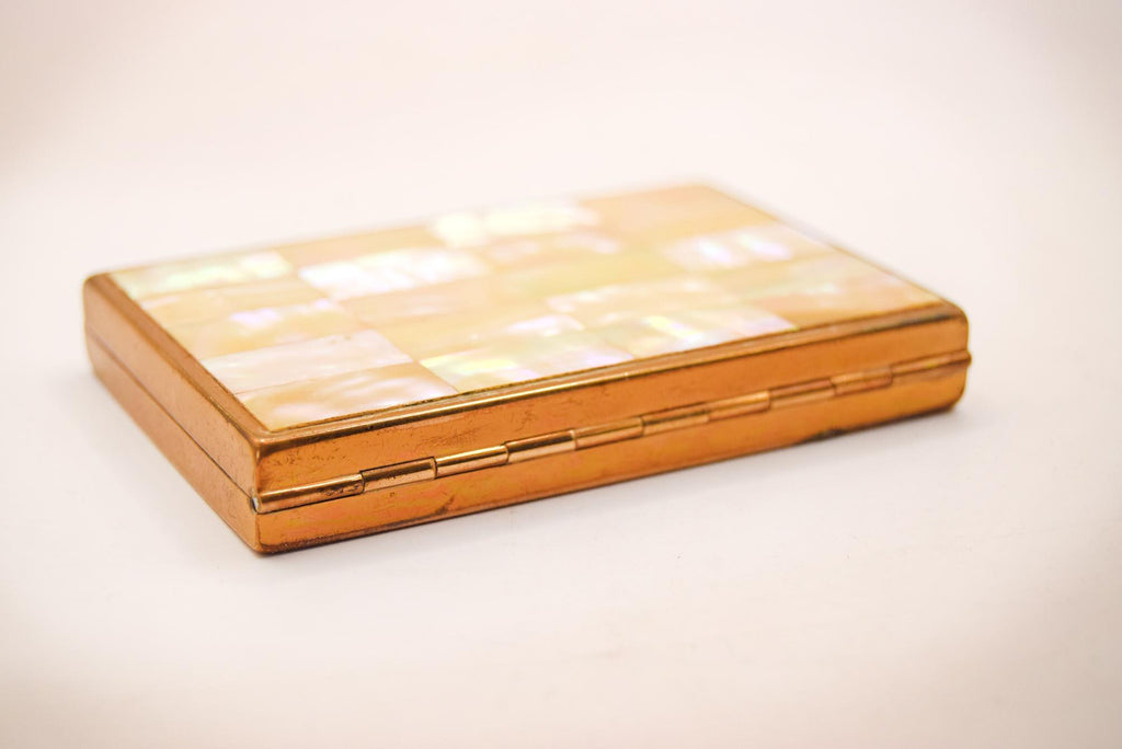 1950s vintage powder compact from AGME Switzerland, featuring a stunning mother-of-pearl lid and golden-tone brass interior.