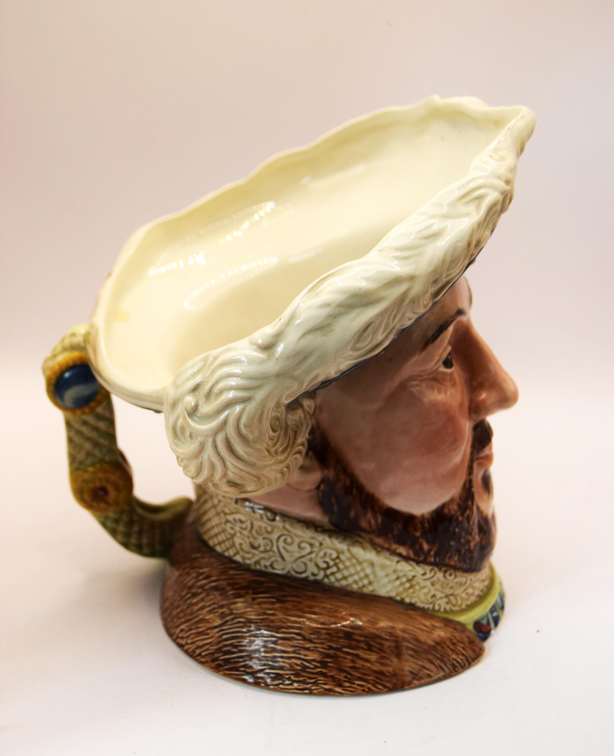 Decorative ceramic piece with a face design on a plain background