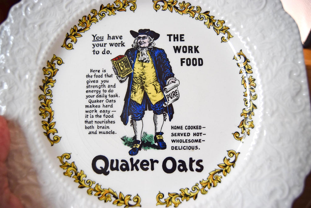Quaker Oats advertisement on a decorative plate with a person holding a box of cereal.