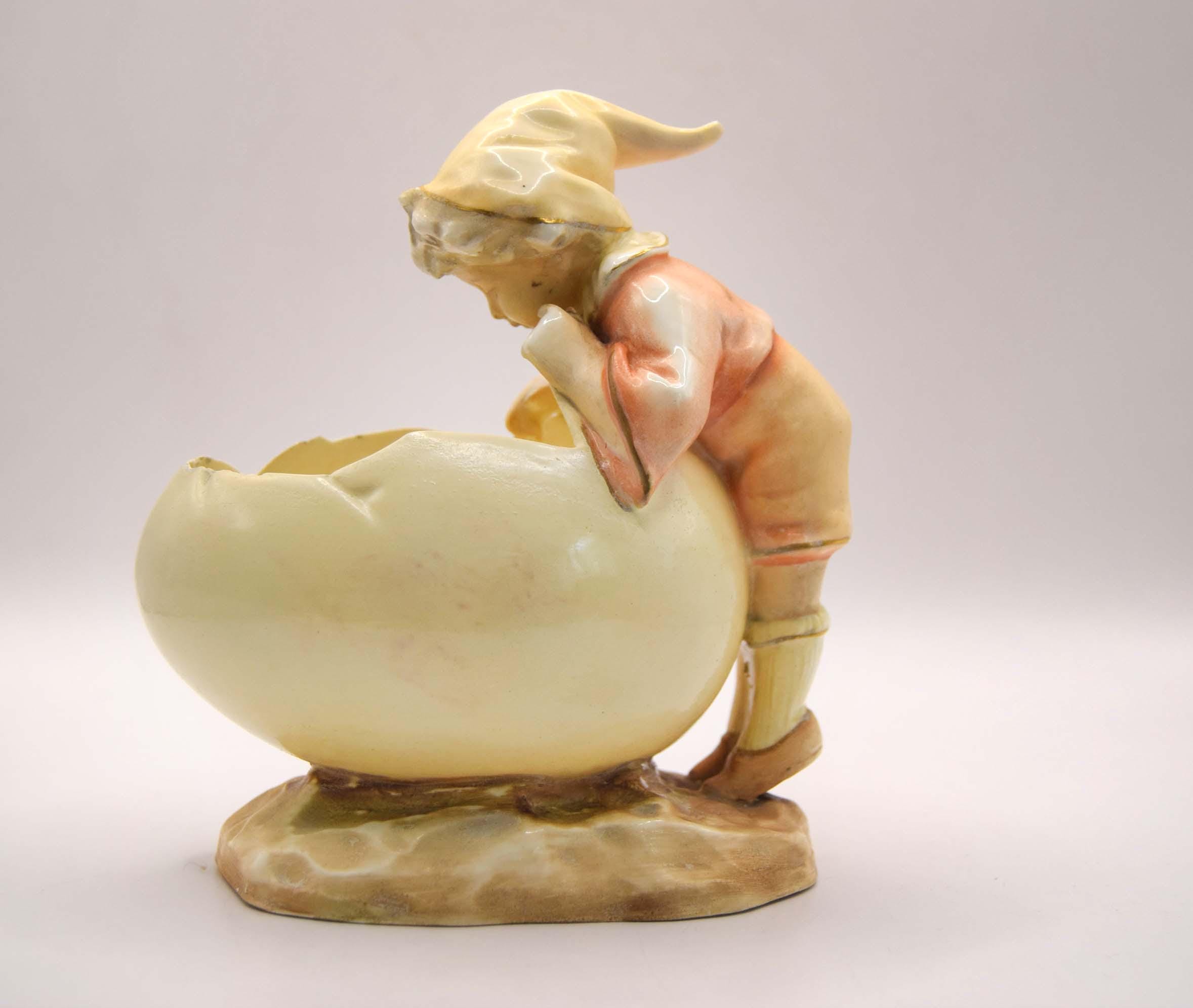 Vintage ceramic figure of a gnome with a basket on a plain background