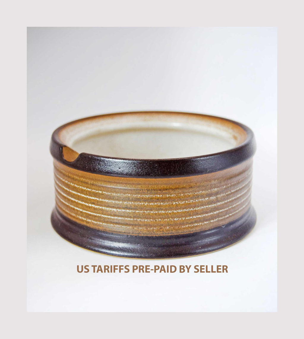 Ceramic bowl with brown and beige stripes on a white background