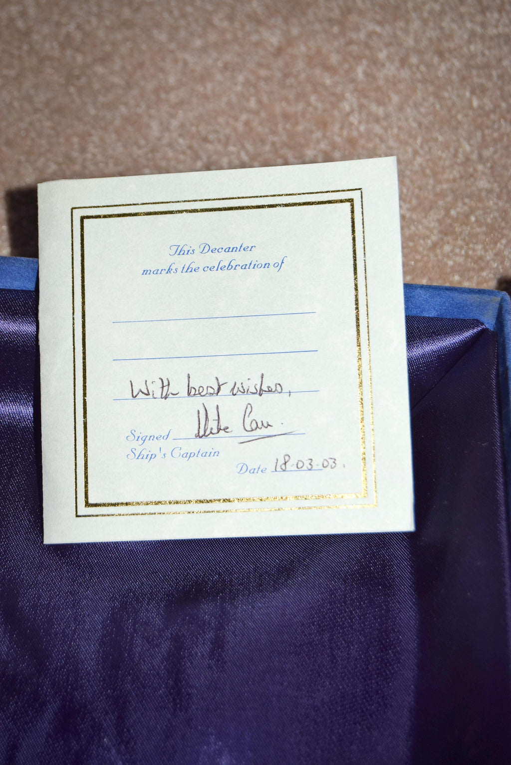 White card with blue text on a purple fabric background