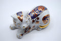 Decorative ceramic cat figurine with intricate patterns on a white background