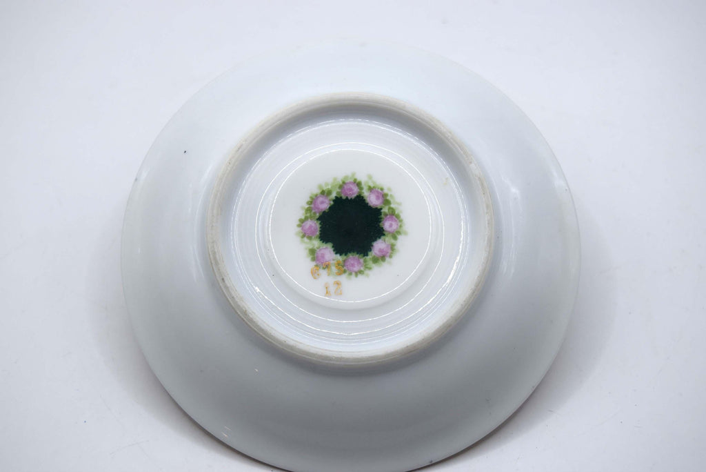 White ceramic bowl with decorative floral pattern on a white background