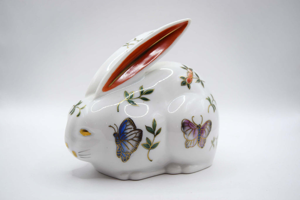 Decorative ceramic rabbit with butterfly designs on a white background