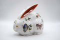Decorative ceramic rabbit with butterfly designs on a white background