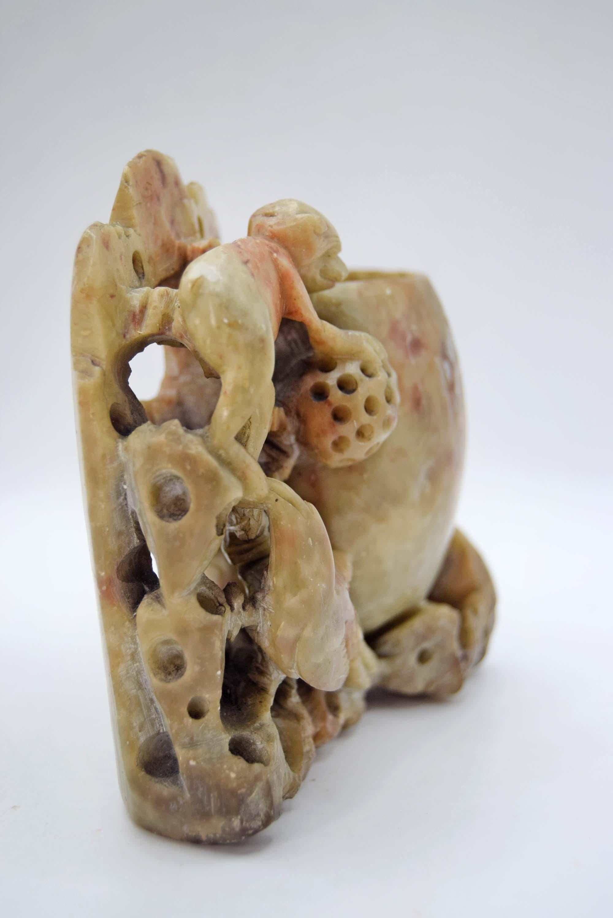 Carved stone monkey sculpture on a white background 