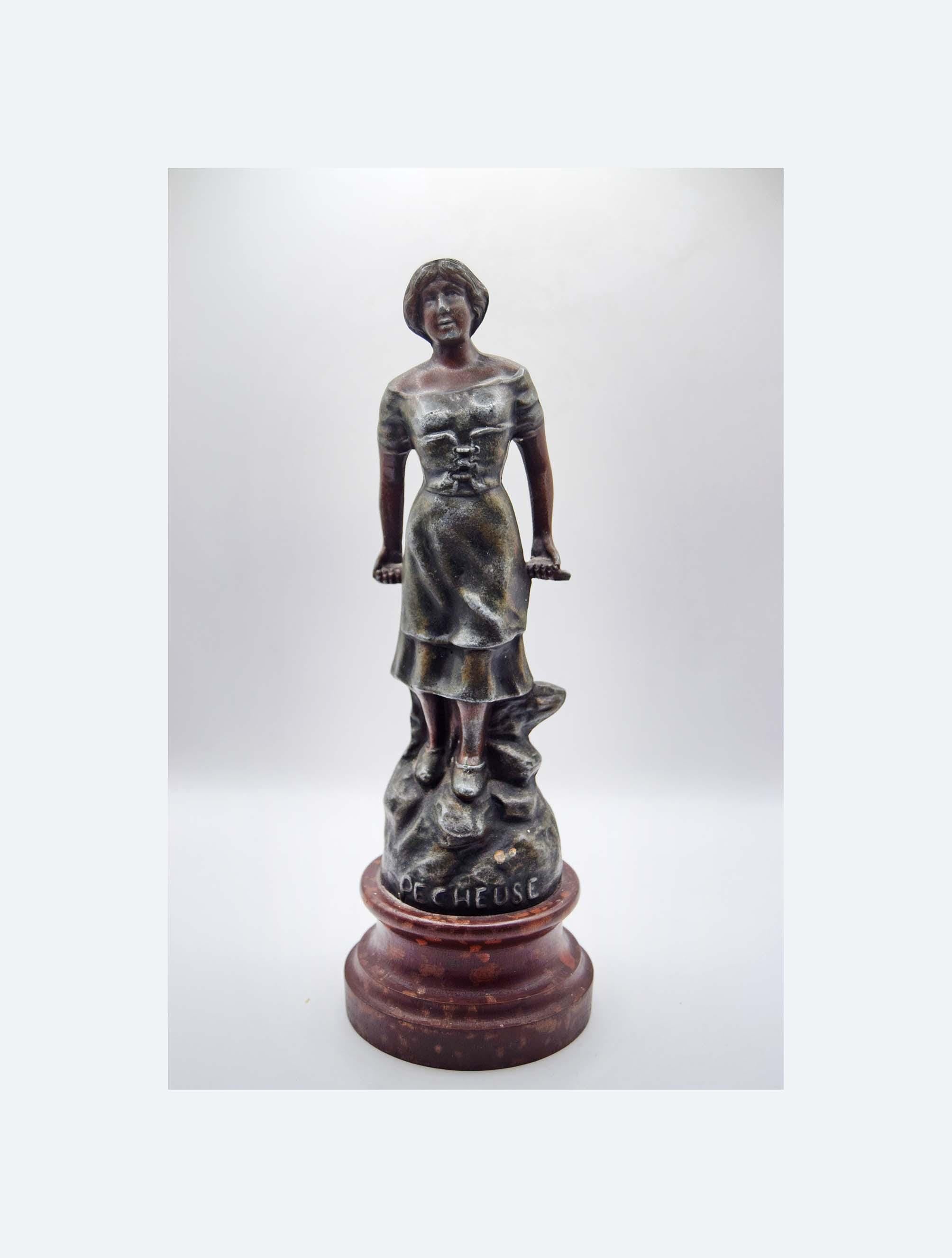 Bronze statue of a woman on a white background.  Adolphe Jean Lavergne.  Pecheuse