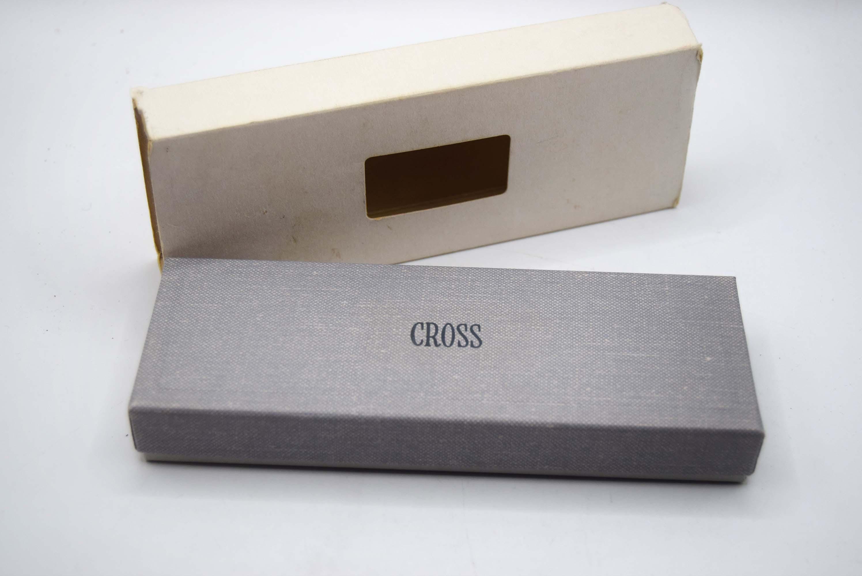 Gray 'Cross' branded box on a white background