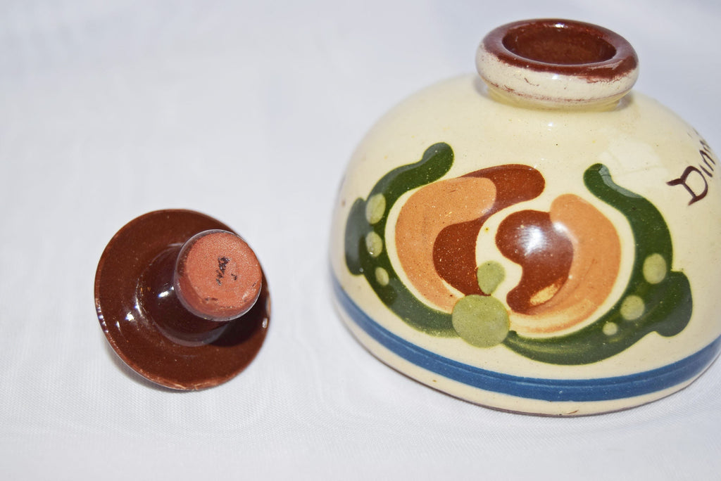 Decorative ceramic jar with lid on a white background