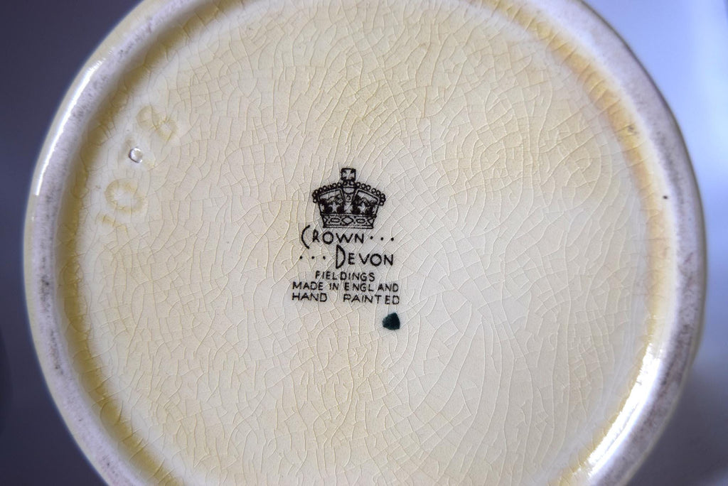 Crown Devon logo on a ceramic plate with a plain background 