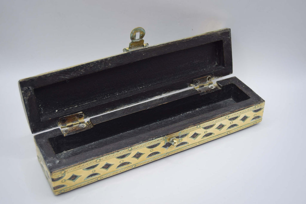 Wooden jewelry box or pencil case with decorative patterns on a white background