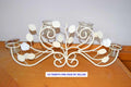 Decorative candle holder with floral design on a wooden surface