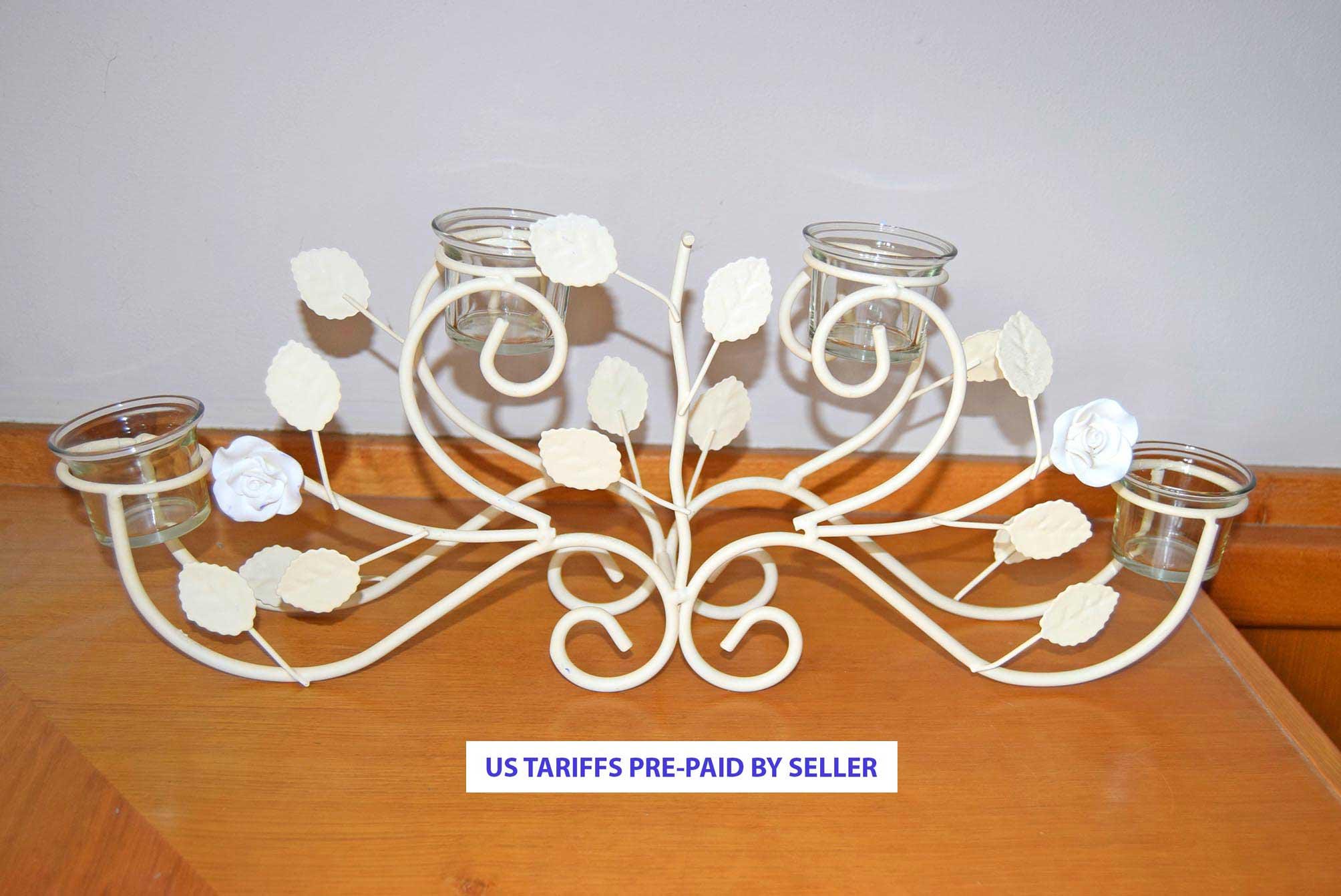 Decorative candle holder with floral design on a wooden surface