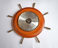 Decorative wall  barometer with wooden rim and brass spokes on a white background