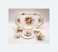  porcelain tea set with floral designs on a plain background