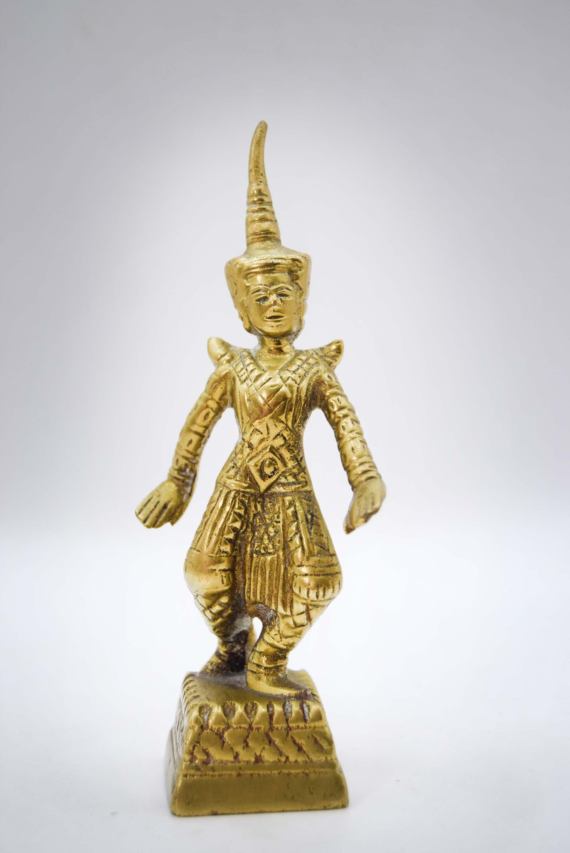 Gold figurine on a white background