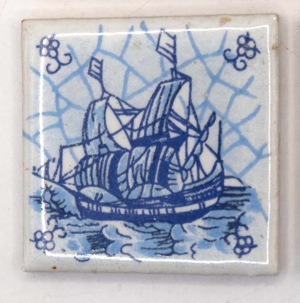 Decorative tile with a blue ship design on a white background