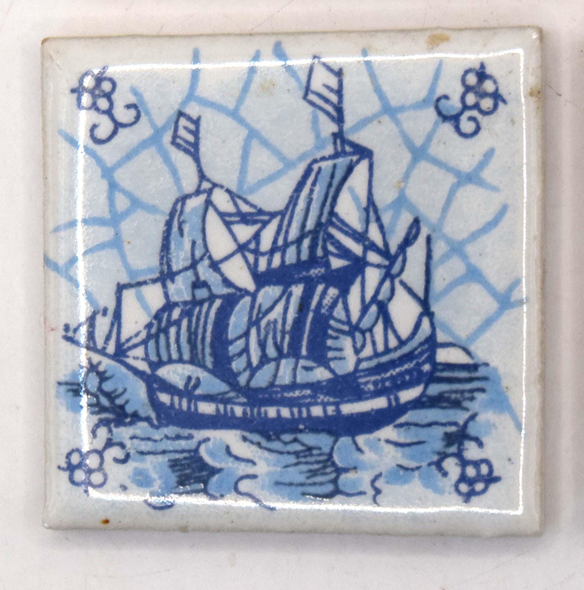 Decorative tile with a blue ship design on a white background