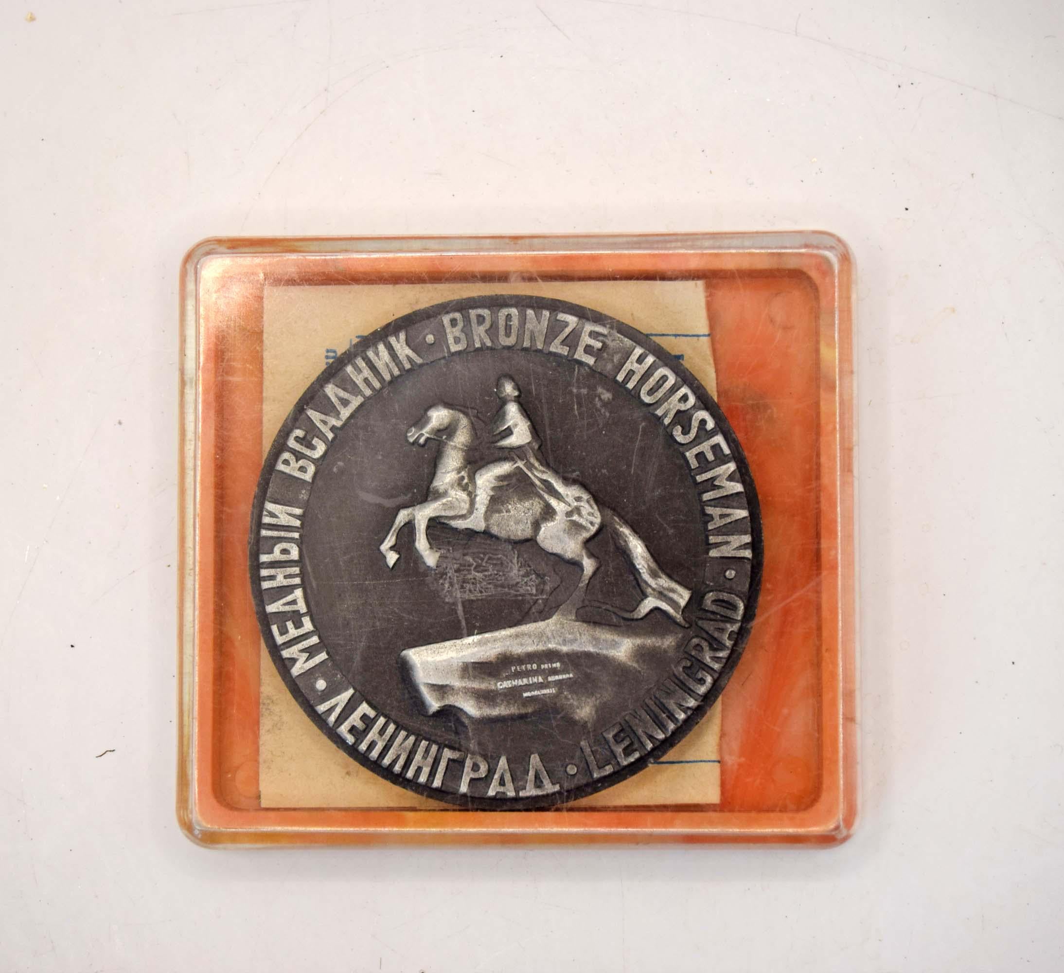 Bronze plaque with 'Bronze Horseman' sculpture on a wooden base