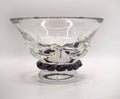 A clear glass bowl with a textured, molded wave-like design on the body and a black twisted rope-style base, shown on a plain light gray background.