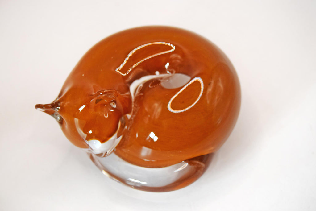 Vintage handblown art glass sleeping cat figurine/paperweight. Handcrafted by the renowned Langham Glass studio in Norfolk, England, this piece features a beautifully stylized, tightly curled feline silhouette.
