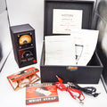 Vintage Histion apparatus kit including a black dial device, open black case with papers, Elastocrepe wrist strap box, red and black wires, and accessories on a white surface.