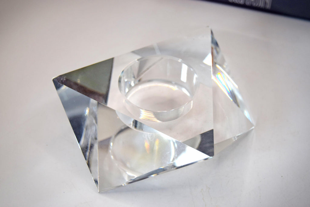 multi-faceted geometric design that beautifully catches and refracts candlelight. It bears the etched, signed "Oleg Cassini" signature on the base and comes safely nestled inside its original sleek gray, satin-lined presentation box.