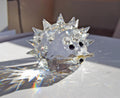 Designed by Max Schreck as part of the beloved "In the Summer Meadow" collection, this charming hedgehog is crafted from premium Austrian faceted clear lead crystal. It features an array of precisely cut, pointed crystal quills that beautifully catch and refract sunlight into dazzling prism displays.