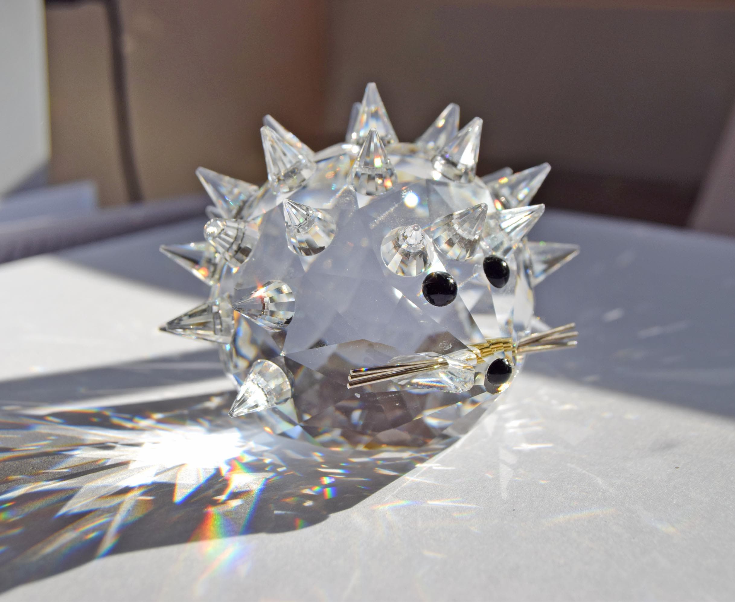 Designed by Max Schreck as part of the beloved "In the Summer Meadow" collection, this charming hedgehog is crafted from premium Austrian faceted clear lead crystal. It features an array of precisely cut, pointed crystal quills that beautifully catch and refract sunlight into dazzling prism displays.
