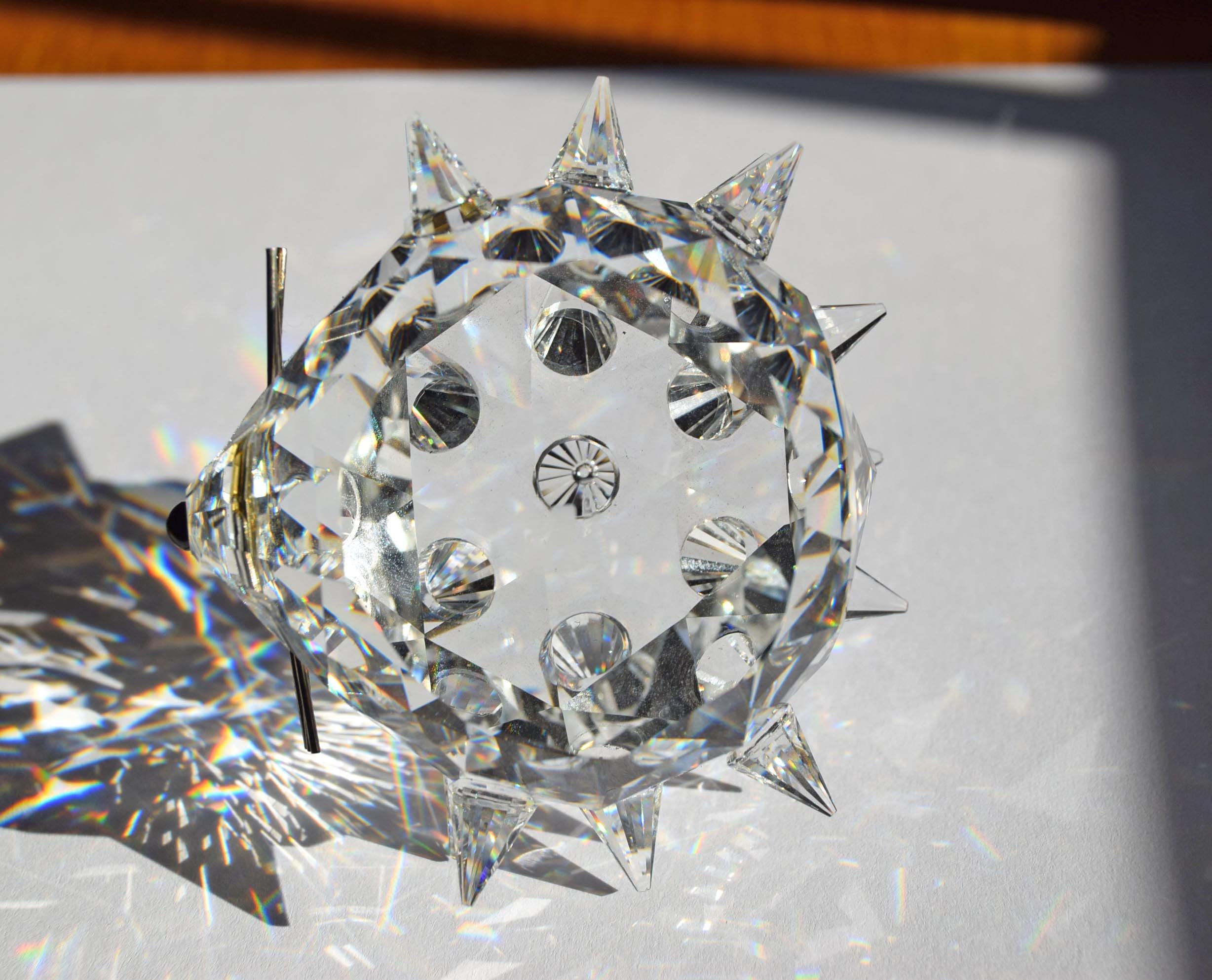 Designed by Max Schreck as part of the beloved "In the Summer Meadow" collection, this charming hedgehog is crafted from premium Austrian faceted clear lead crystal. It features an array of precisely cut, pointed crystal quills that beautifully catch and refract sunlight into dazzling prism displays.