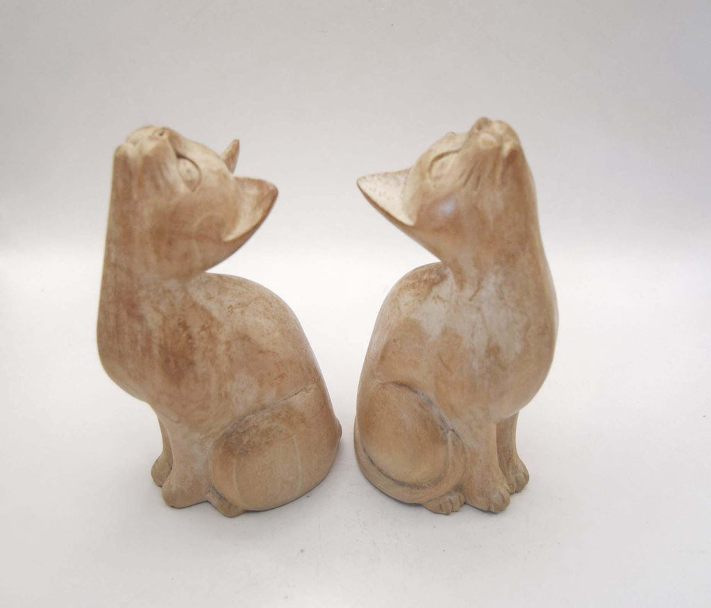 Pair of Vintage Hand-Carved Wooden Cat Figurines. Beautiful pair of stylized, hand-carved wooden cat statues. Crafted with a beautiful minimalist form, these feline companions feature elegantly curved necks and an upward-gazing expression that captures the curious nature of cats.
