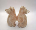 Pair of Vintage Hand-Carved Wooden Cat Figurines. Beautiful pair of stylized, hand-carved wooden cat statues. Crafted with a beautiful minimalist form, these feline companions feature elegantly curved necks and an upward-gazing expression that captures the curious nature of cats.