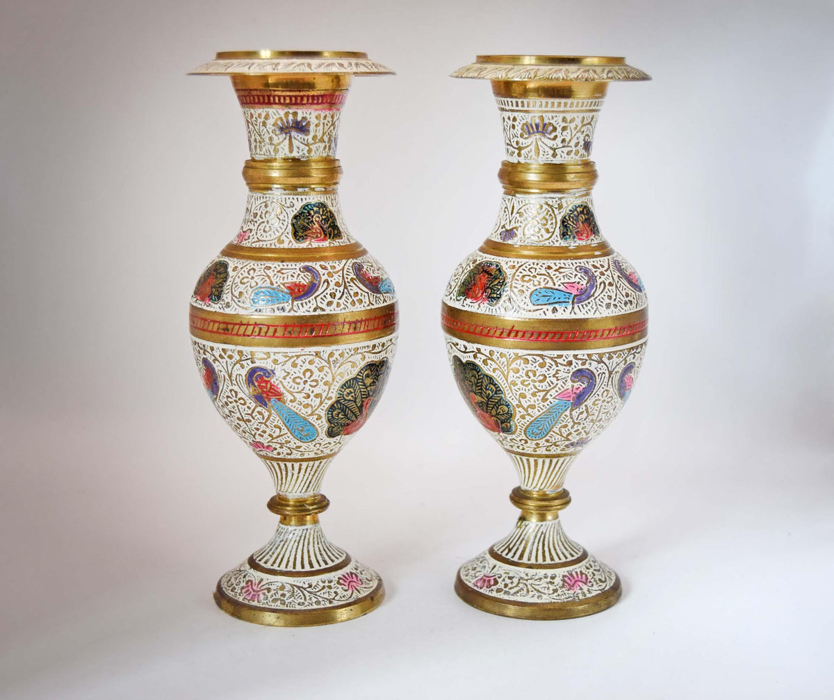 
Stunning Pair of Vintage Kashmiri Meenakari Brass and Enamel Peacock Vases. Masterfully handcrafted in India, these eye-catching mantle urns feature highly detailed, hand-painted majestic peacocks surrounded by intricate white floral scrollwork and vibrant turquoise, red, and gold accents.